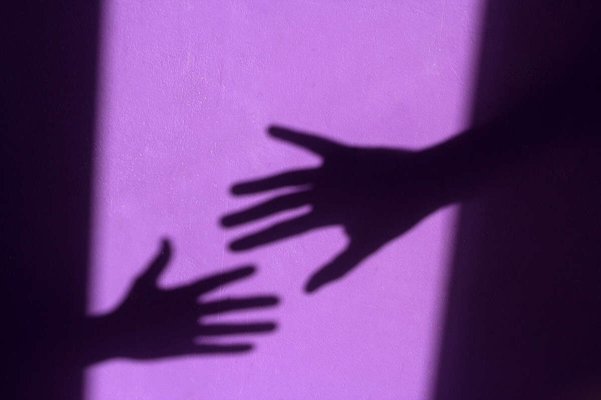 purple shabby wall with palm shadows