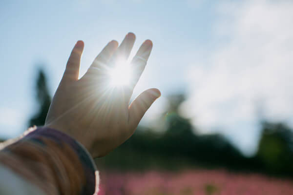 hand-reaching-to-sun-beautiful-sunbeam-in-female-2021-09-02-08-42-17-utc