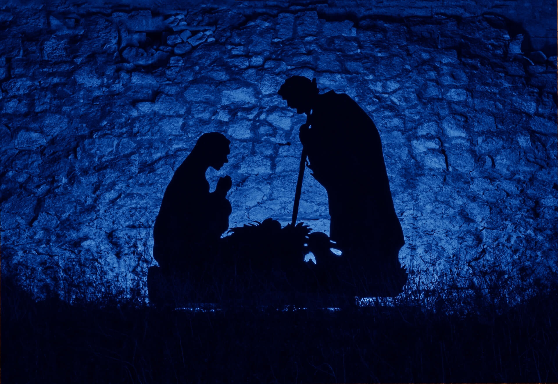 Christmas man nativity scene installation on the theme of the birth of Jesus Christ, shadow and silhouette. Street decoration on eve of Xmas. Toned image with trend color of 2020 year Classic blue Christmas installation on the theme of the birth of Jesus Christ